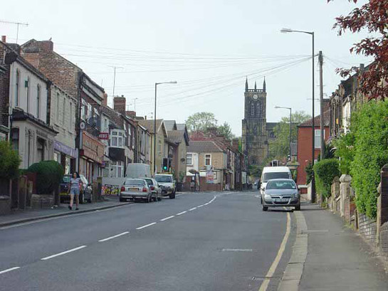 Figure 1: Rawmarsh Hill. The irregular terraced buildings here date to the second half of the 19th century as the earlier village (which lies to the far side of the medieval church) expanded to the south, largely in response to the growth of the Park Gate Iron and Steel Co